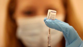 Pharmacist fills a syringe with the Pfizer COVID-19 booster vaccination at a vaccination booster shot clinic