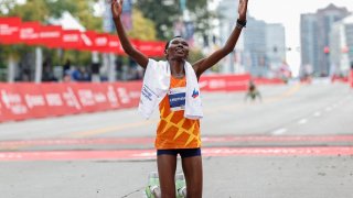 Kenya’s Ruth Chepngetich reacts after winning the Elite Women’s 2021 Bank of America Chicago Marathon on October 10, 2021 in Chicago, Illinois. – Reigning world champion Ruth Chepngetich of Kenya made a triumphant US debut on by winning the women’s title at the 43rd Chicago Marathon. Chepngetich won in an unofficial time of 2hrs 22mins 31secs to defeat American runner-up Emma Bates by 1:49 with another Sara Hall, also of the United States, third in 2:27:19. (Photo by KAMIL KRZACZYNSKI / AFP) (Photo by KAMIL KRZACZYNSKI/AFP via Getty Images)