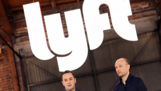 Lyft President John Zimmer (R) and CEO Logan Green speak as Lyft lists on the Nasdaq at an IPO event in Los Angeles March 29, 2019.