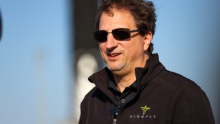 Firefly Aerospace CEO Tom Markusic stands in front of the company’s Alpha rocket at Vandenberg Space Force Base’s SLC-2.