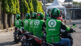 Gojek riders wait for their delivery orders at a distribution centre in Surabaya, Indonesia on May 17, 2021.
