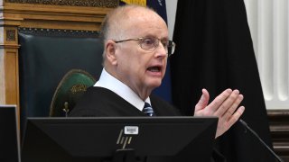 Circuit Court Judge Bruce Schroeder addresses the jury pool at the start of jury selection on the first day of trial for Kyle Rittenhouse in Kenosha, Wis.