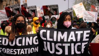 Climate activists hold up banners during a protest organized by the Cop26 Coalition in Glasgow, Scotland, Nov. 6, 2021.