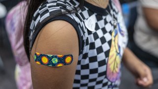 A child wears a band-aid after receiving a dose of the Pfizer-BioNTech Covid-19 vaccine.