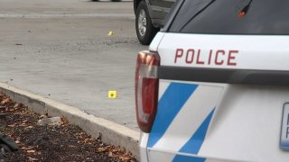 Evidence markers lay in the parking lot of a Chatham Walgreens where a man was shot and a child suffered a graze wound on Thursday, Nov. 11, 2021.