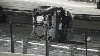 A black SUV lays on its side on a roadway after a crash in Chicago