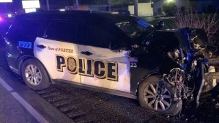 A black Porter police vehicle, with white trim and black lettering, shows heavy front-end damage after a high-speed collision during a pursuit