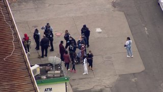 An aerial view shows Chicago police officers talking with eyewitnesses on the scene of a shooting in the Stony Island Park neighborhood.