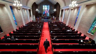 Rev. Meredith Mills delivers a sermon from the pulpit for some 30 attendants during the second service of the day in the sanctuary at Westminster United Methodist Church