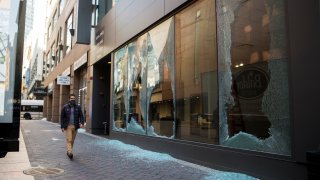 shattered storefront of an empty retail space