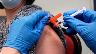 A woman receives a COVID-19 vaccine injection