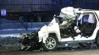 A badly-damaged white SUV, with its front windshield slammed into the front seat of the vehicle, after a crash in Archer Heights on January 30th.