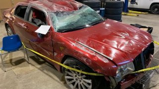 A red vehicle is pictured with a smashed windshield after it crashed in Indiana on Jan. 8, 2022.