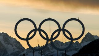 Large Olympic rings are seen at sunset on the roof of the hotel being used as the athlete's village for the alpine events in the village of Sestriere, northern Italy,