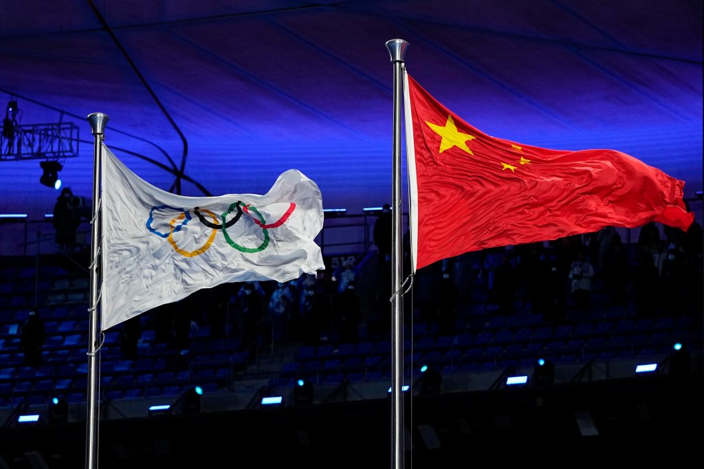 The Chinese and Olympic flags fly during the opening ceremony of the 2022 Winter Olympics, Friday, Feb. 4, 2022, in Beijing.