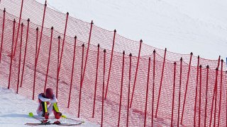 Mikaela Shiffrin, of the United States sits on the side of the course after skiing out in the first run of the women's slalom at the 2022 Winter Olympics, Wednesday, Feb. 9, 2022, in the Yanqing district of Beijing, China.