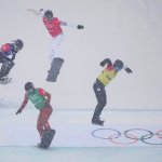Kristina Paul, of the Russian Olympic Committee, right, leads the pack, followed by Canada's Meryeta O'Dine, United States Faye Gulini and France's Chloe Trespeuch, during the mixed team snowboard cross finals at the 2022 Winter Olympics, Feb. 12, 2022, in Zhangjiakou, China.