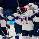 United States players celebrate after a goal by Kenny Agostino during a preliminary round men's hockey game against Canada at the 2022 Winter Olympics, Feb. 12, 2022, in Beijing.
