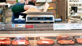 employee weighs a cut of meat