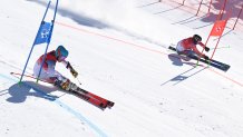 USA's River Radamus (L) and Slovakia's Adam Zampa compete in the mixed team parallel round of 16 event during the 2022 Winter Olympics at the Yanqing National Alpine Skiing Centre in Yanqing China on Feb. 20, 2022.