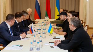 Members of delegations from Ukraine and Russia, including Russian presidential aide Vladimir Medinsky (2L), Ukrainian presidential aide Mykhailo Podolyak (2R), Volodymyr Zelensky's "Servant of the People" lawmaker Davyd Arakhamia (3R), hold talks in Belarus' Gomel region on Feb. 28, 2022, following the Russian invasion of Ukraine.