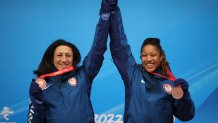 Bronze medal winners Elana Meyers Taylor and Sylvia Hoffman of Team United States celebrates their win following the 2-woman bobsled event at the 2022 Winter Olympic Games, Feb. 19, 2022, in Yanqing, China.