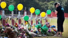 SANTA FE, TX - MAY 22:  Mourners visit a memorial in front of Santa Fe High School on May 22, 2018 in Santa Fe, Texas. The makeshift memorial honors the victims of last Friday's shooting when 17-year-old student Dimitrios Pagourtzis entered the school with a shotgun and a pistol and opened fire, killing 10 people.  (Photo by Scott Olson/Getty Images)