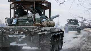 Russian tanks move across the town of Armyansk in northern Crimea on Feb. 24, 2022.