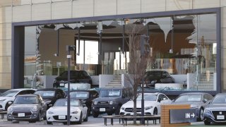 A car dealership’s window is broken following a strong earthquake in Koriyama, Fukushima prefecture, Japan in this photo taken by Kyodo on March 17, 2022.