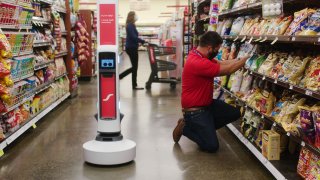 The Tally 3.0 autonomous mobile robot scans inventory in a grocery store.