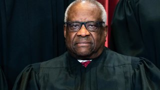 FILE - Associate Justice Clarence Thomas sits during a group photo at the Supreme Court in Washington, Friday, April 23, 2021. On Monday, Feb. 7, 2022, Georgia’s state Senate voted to erect a monument to U.S. Supreme Court Justice and Georgia native Thomas.
