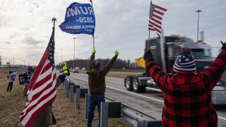 Demonstrators protesting COVID-19 mask and vaccine mandates greet a 'Freedom and Accountability' caravan heading to Washington, D.C., on March 3, 2022, in Pataskala, Ohio.