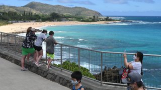 People look at Sandy Beach