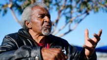 Lovia Primous, 67, speaks with some of his friends at the Ozanam Manor temporary housing for people 50 and up seeking permanent housing, Monday, Jan. 24, 2022, in Phoenix. A stroke started the 67-year-old Army veteran on his downward spiral, costing him his job and forcing him to sleep in his Honda Accord. "Life has been hard," said Primous, who grew up on in a once- segregated African American neighborhood of south Phoenix. "I'm just trying to stay positive."