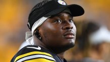 Dwayne Haskins wearing a Steelers uniform and hat