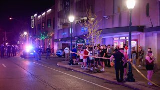 BLOOMINGTON, INDIANA, UNITED STATES – 2022/04/22: Members of law enforcement work at the scene of a shooting that left three wounded at the Kalao Night Club on North Walnut Street. Police also located a fourth gunshot victim at another location on 6th Street, but it was unclear if the shootings were related, and police are treating the scene as a separate investigation. Then awhile later police pursued a vehicle before it crashed on the campus of Indiana University. The vehicle’s occupants ran on foot, it’s unclear if the vehicle was connected to the shootings. (Photo by Jeremy Hogan/SOPA Images/LightRocket via Getty Images)