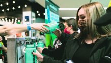 Fans use the water refill station at a Billie Eilish concert