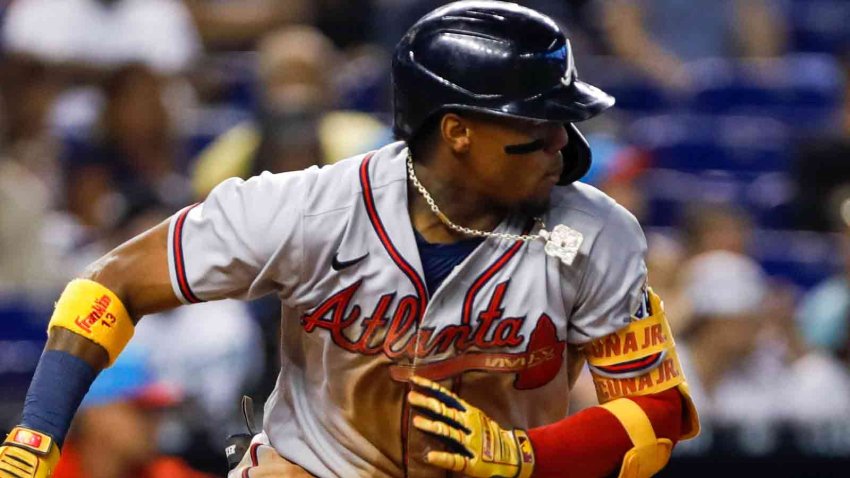 2 fans charged after running onto Coors Field, grabbing Braves outfielder Ronald  Acuña Jr.