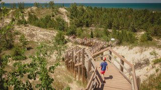Boy hiking along dune succession trail in Indiana Dunes National Park.