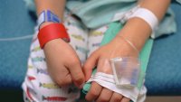 A worried young boy in a hospital bed being treated for croup.
The red bracelet is to notify healthcare professionals of an allergy to penicillin.