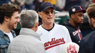 Actor Tom Hanks holds Wilson the volleyball from his film "Cast Away" before the game between the Cleveland Guardians and the San Francisco Giants at Progressive Field. Hanks threw out the first pitch. (Credit: USA TODAY Sports)