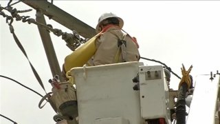 A file photo of a ComEd employee repairing power lines in Illinois.