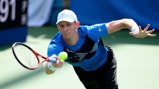 Kevin Anderson, of South Africa, reaches for a return against Jenson Brooksby during a match in the Citi Open tennis tournament