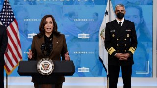 U.S. Vice President Kamala Harris, flanked by Surgeon General Vivek Murthy (R),