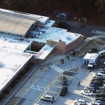 People gather at the scene of a mass school shooting at Sandy Hook Elementary School