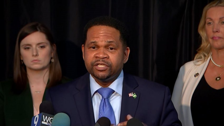 Republican gubernatorial candidate Richard Irvin, wearing a blue shirt, tie and suit jacket, stands behind a microphone during a press conference