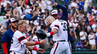 CHICAGO, ILLINOIS – MAY 29: Jake Burger #30 of the Chicago White Sox gets doused with water after his game-winning single in the 12th inning against the Chicago Cubs at Guaranteed Rate Field on May 29, 2022 in Chicago, Illinois. (Photo by Quinn Harris/Getty Images)