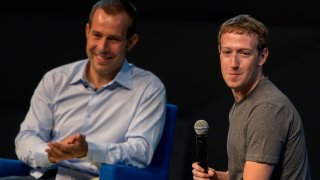 Mark Zuckerberg, chief executive officer of Facebook Inc., right, pauses while speaking as Javier Olivan, vice president of growth and analytics at Facebook Inc., looks on at Billionaire Carlos Slim’s Telmex Foundation annual event for scholarship students in Mexico City, Mexico, on Friday, Sept. 5, 2014. Zuckerberg said he’s willing to spend whatever it takes to spread Internet access around the world.