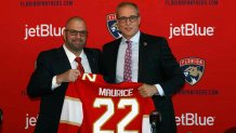 SUNRISE, FL - JUNE 23: General manager Bill Zito presents Paul Maurice with a team jersey after he was introduced as the new head coach of the Florida Panthers at the FLA Live Arena on June 23, 2022 in Sunrise, Florida. (Photo by Joel Auerbach/Getty Images)