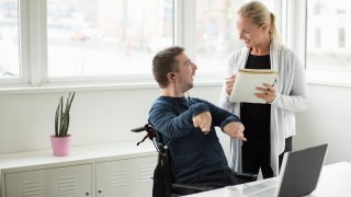 Business man discussing work with colleague in office